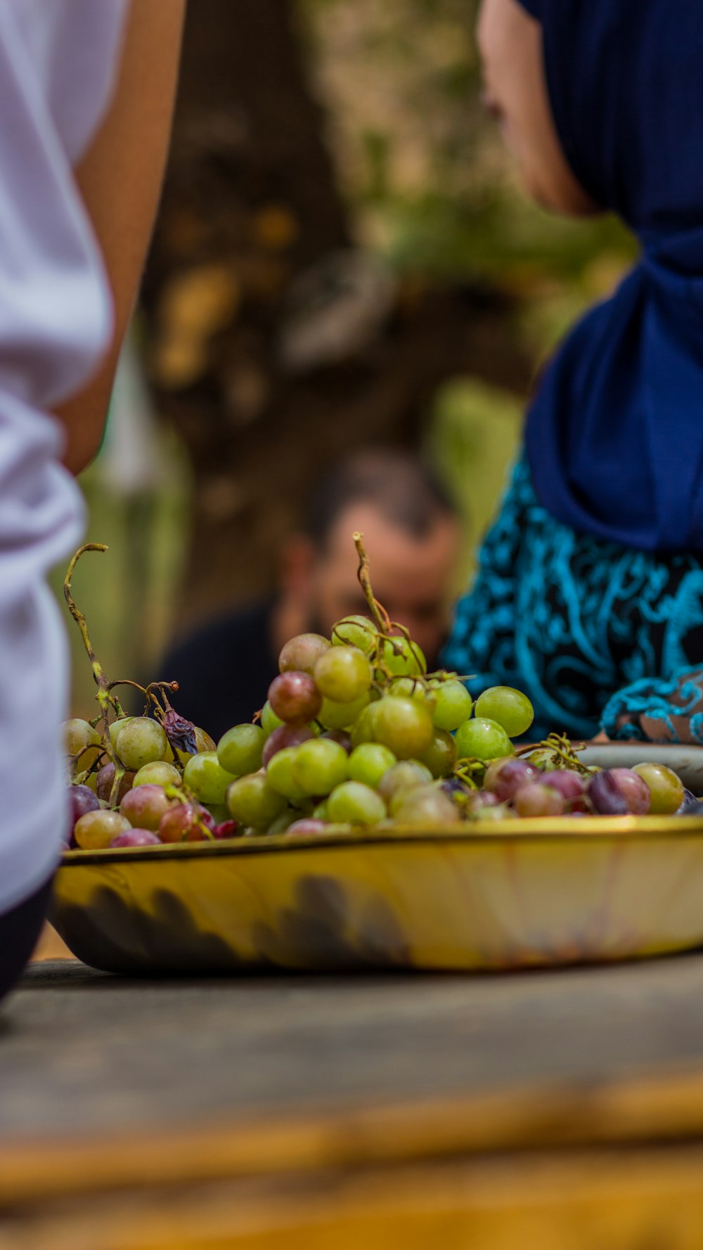 green grapes on yellow plastic container