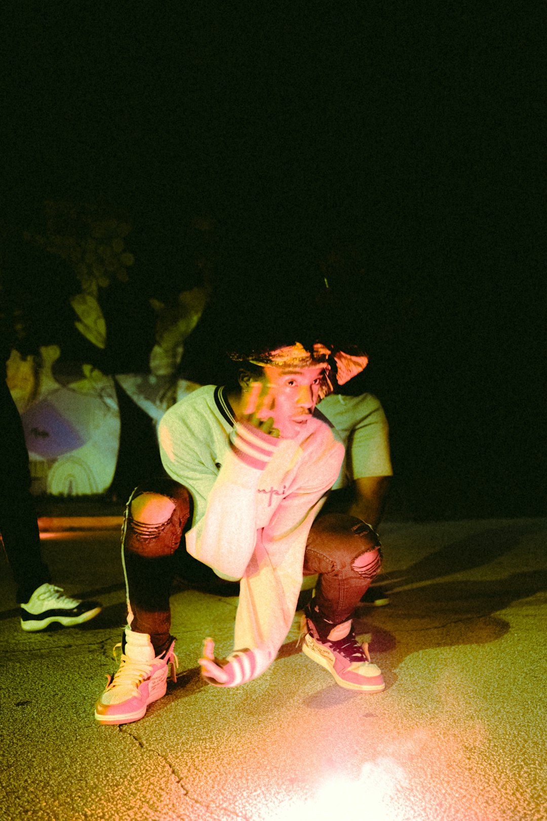 man in white t-shirt and red shorts sitting on floor