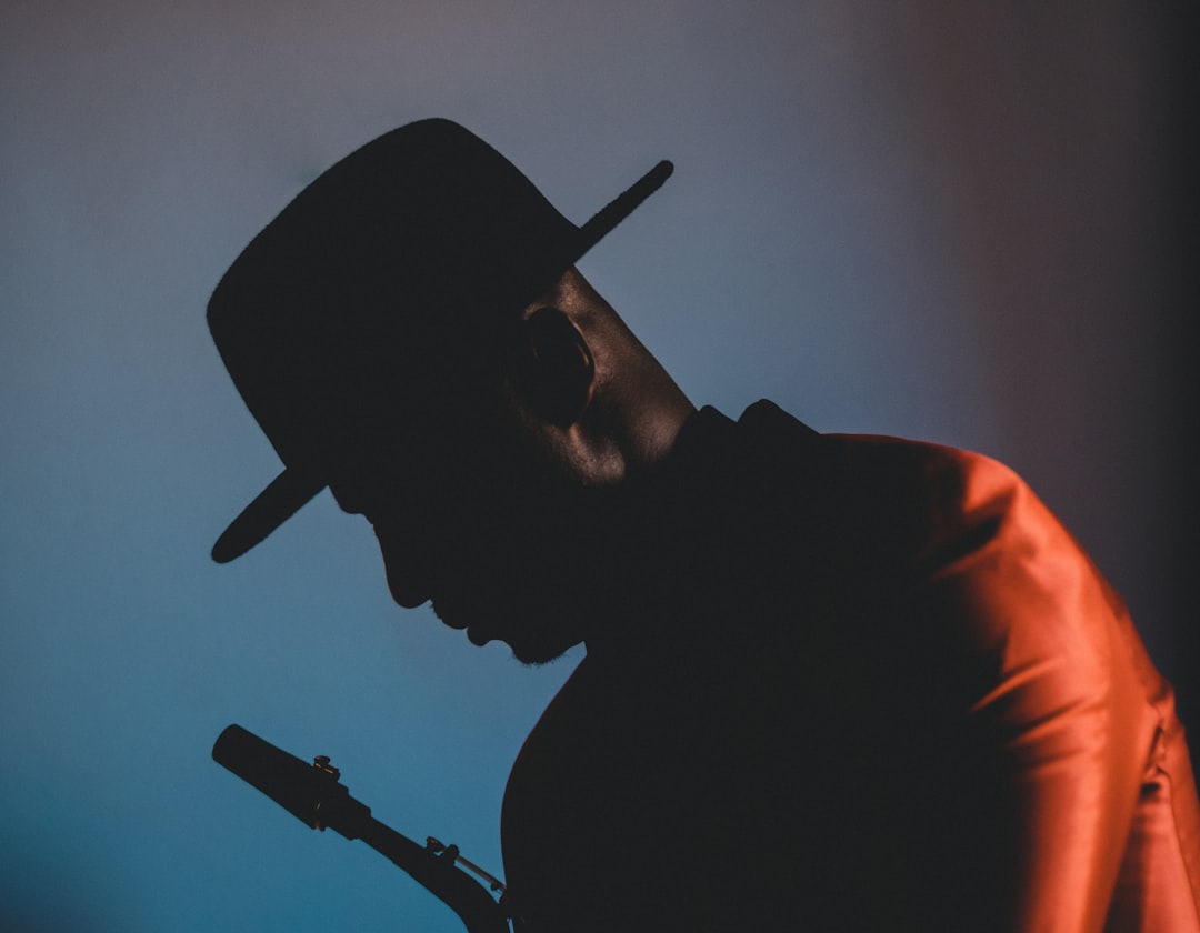 man in black crew neck shirt wearing black fitted cap, Portrait of the best saxophone player in the game