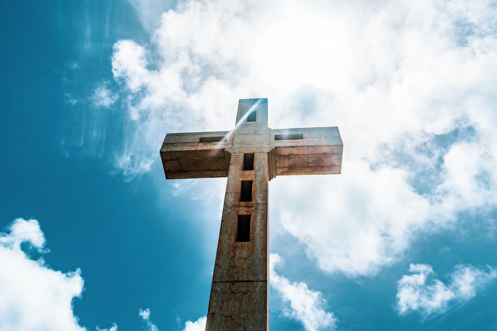 brown wooden cross under blue sky during daytime