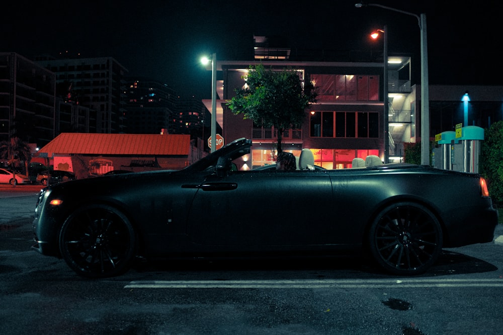 black convertible car parked near building during night time