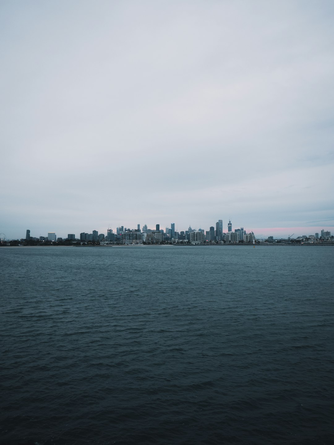 body of water near city buildings during daytime