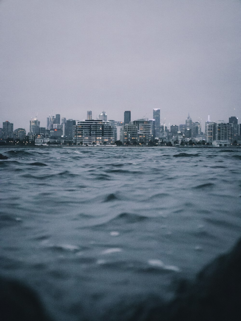 body of water near city buildings during daytime