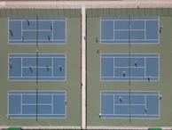 Outdoor games session with students playing tennis and badminton energetically on well-maintained courts.