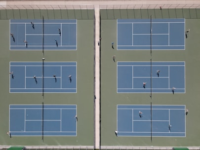 A tennis court with players engaged in a match.