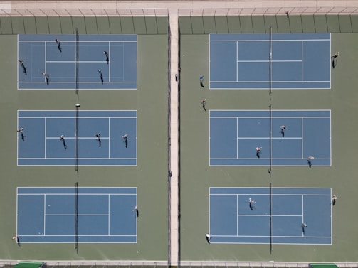 A group of diverse tennis players smiling and shaking hands on a sunny Sydney court.