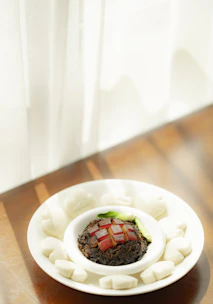 A beautifully plated Chinese fusion dish with vintage-style table setting