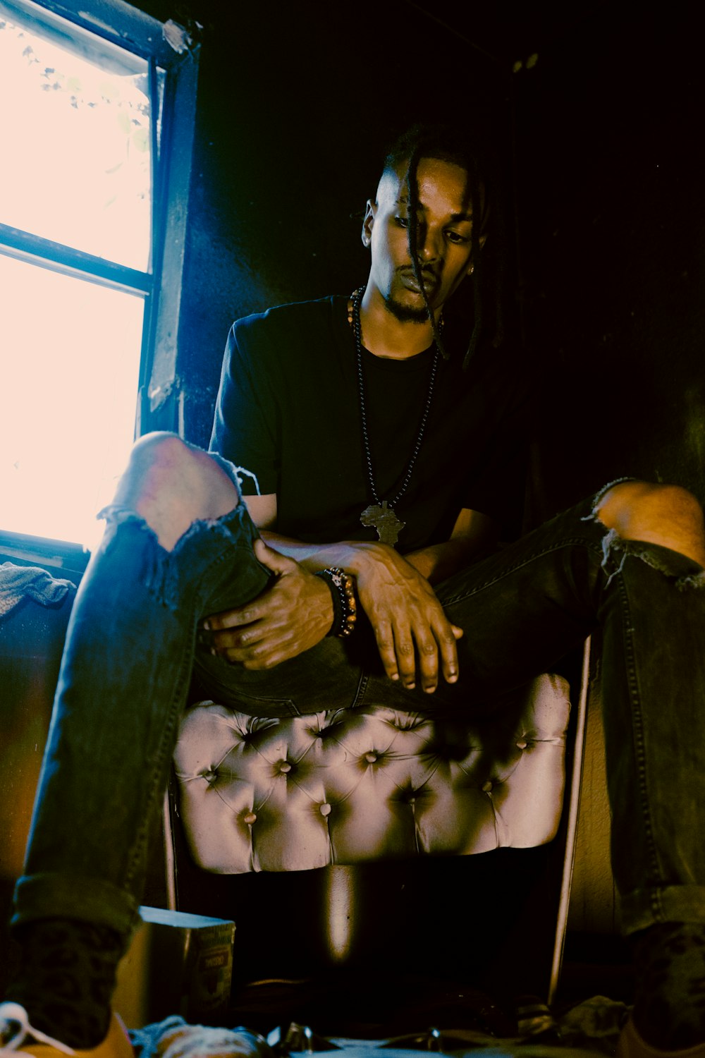 woman in black long sleeve shirt and black pants sitting on black leather chair