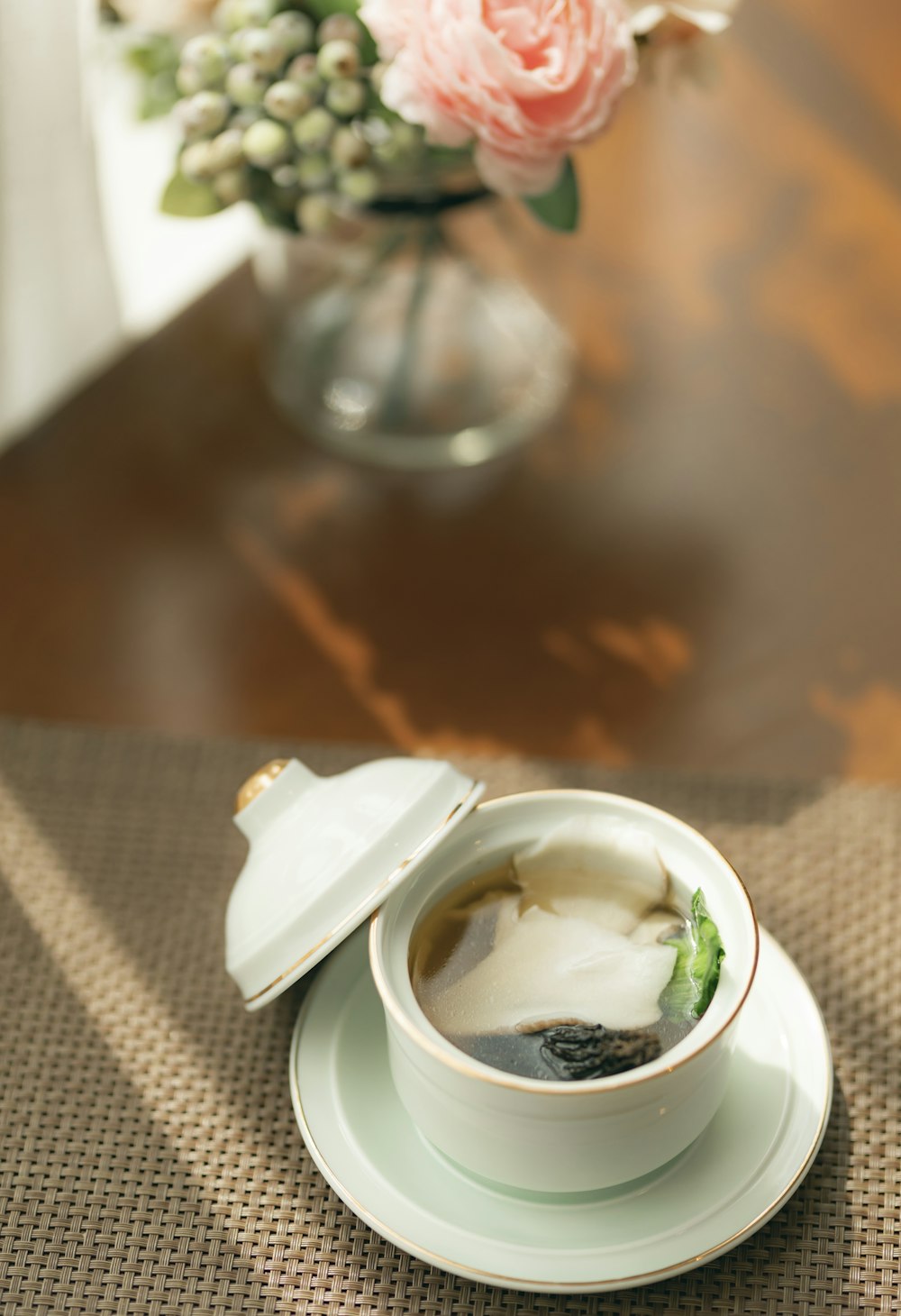 white ceramic bowl on white table cloth