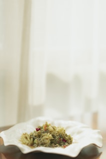 Freshly served sabji with visible steam on a rustic plate inside the clean restaurant section.