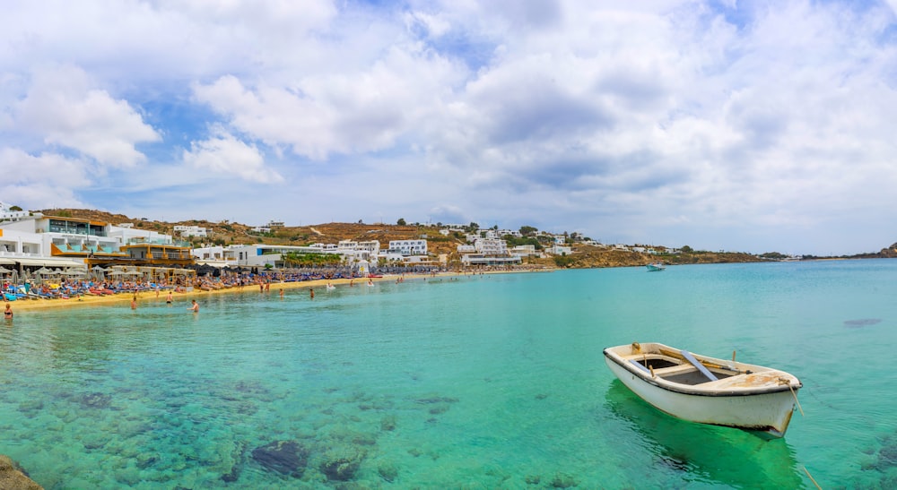 white and blue boat on sea during daytime