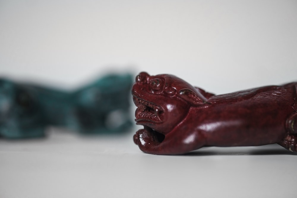 red ceramic elephant figurine on white table