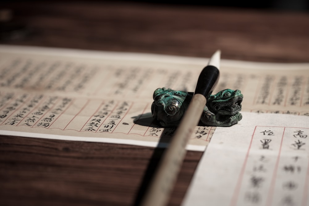 green and brown wooden pencil on newspaper