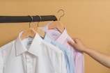 white button up shirt on brown clothes hanger