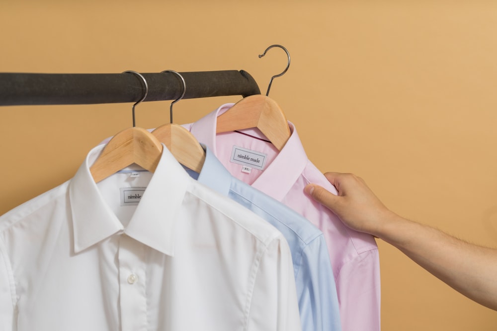 white button up shirt on brown clothes hanger photo – Free Image on Unsplash