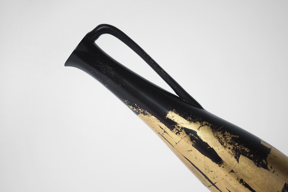 black and gold bottle opener