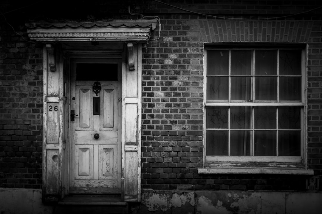 grayscale photo of wooden door