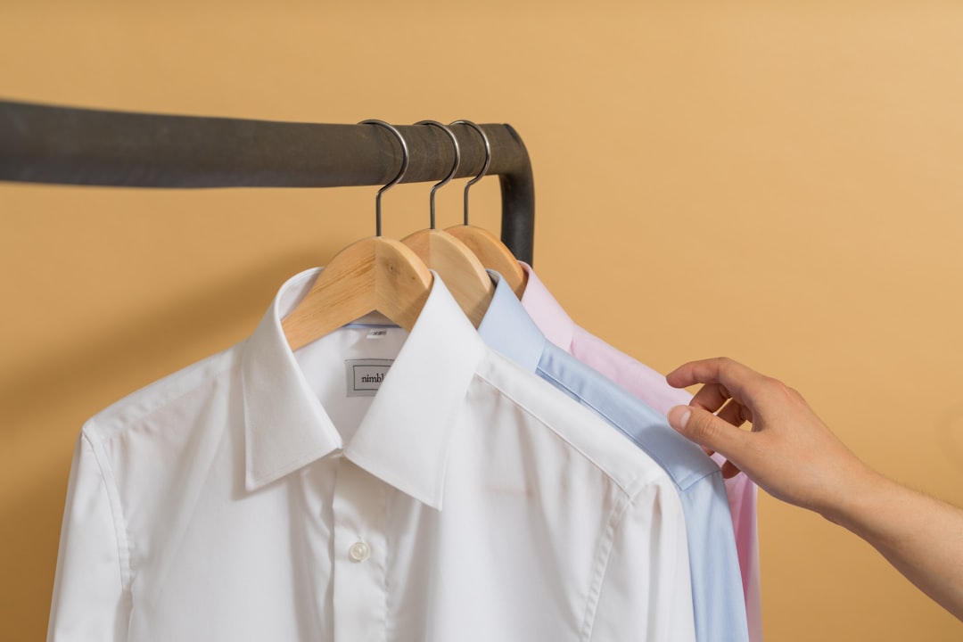white button up shirt on black clothes hanger,