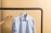 A close-up of a neatly tailored uniform hanging on a rack.