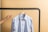 A close-up of a neatly tailored uniform hanging on a rack.