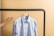 Soft blue shirt displayed neatly on a neutral backdrop with gentle shadows.