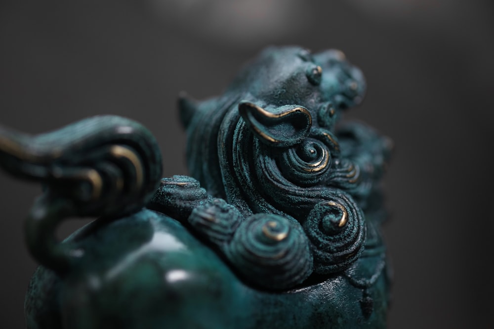 blue and green ceramic figurine