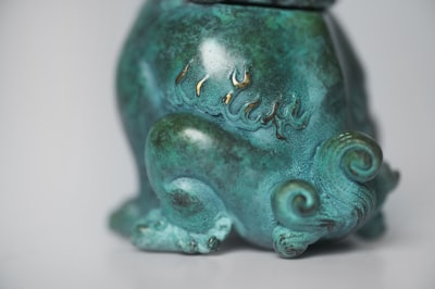 green ceramic vase on white table turquoise zoom background
