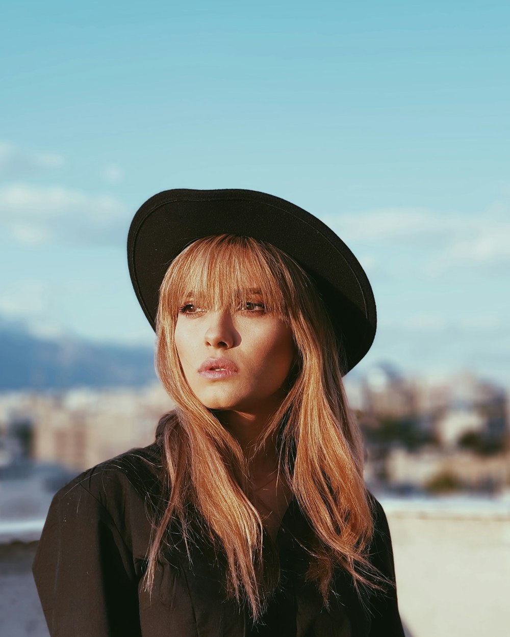 woman in black hat and black coat