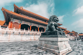 black statue of man on gray concrete bench