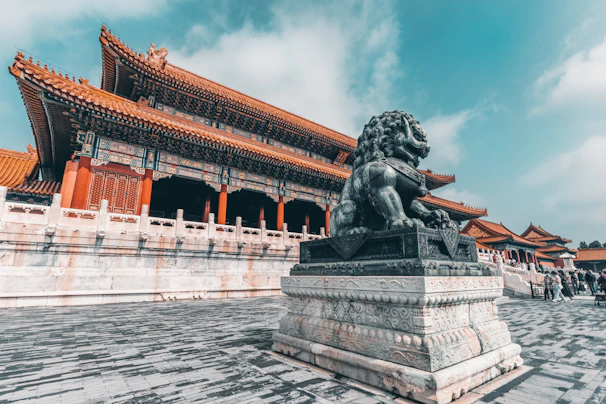 black statue of man on gray concrete bench