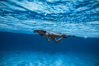 woman in black bikini swimming in water