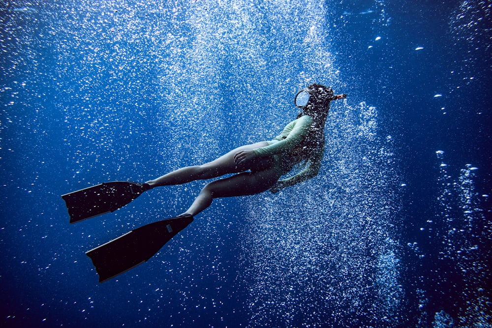 woman in black one piece swimsuit under water