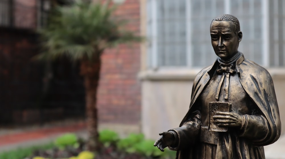 man in black coat statue