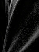 Close-up of the heavy cotton fabric texture on the essential black t-shirt highlighting the quality and detail.