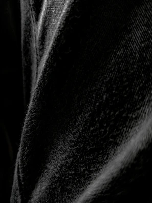 Close-up of the heavy cotton fabric texture on the essential black t-shirt highlighting the quality and detail.