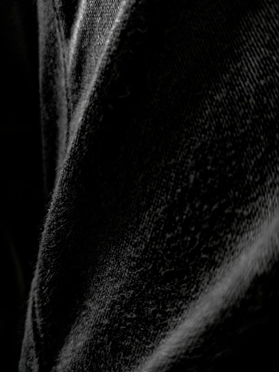 Close-up shot of the premium fabric texture of a black oversized t-shirt highlighting its comfort and quality.