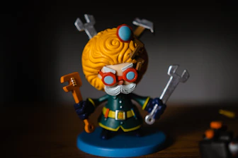 yellow haired man in blue and yellow suit action figure