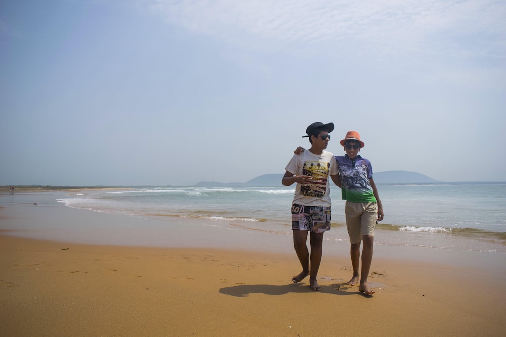 man and woman kissing on beach during daytime