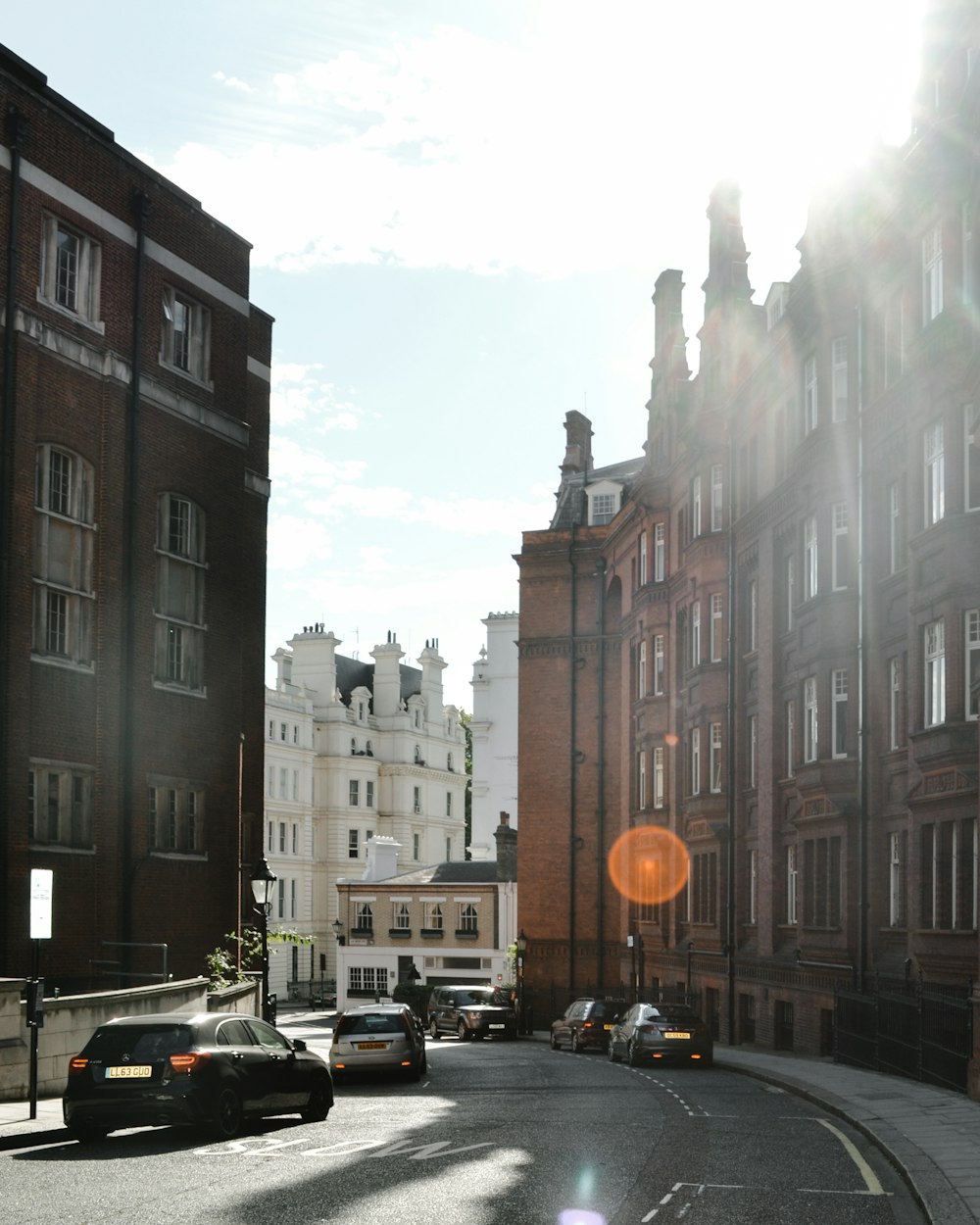 cars parked in front of brown concrete building during daytime