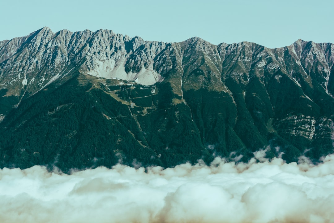 green and brown mountain under white clouds during daytime