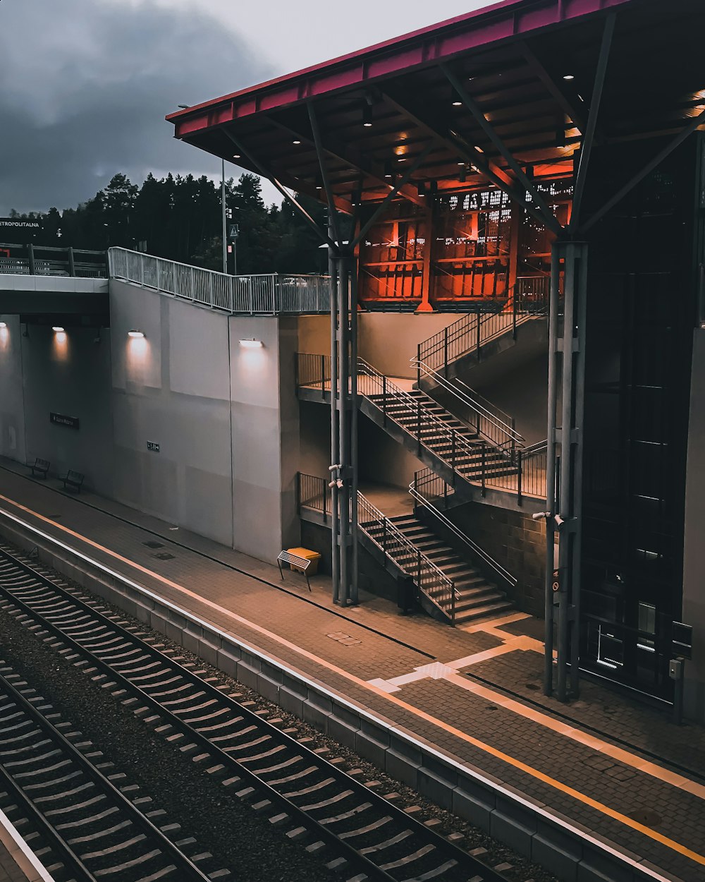 train rail near white building during night time