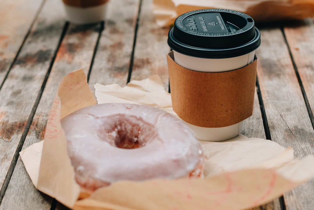 brown and black coffee cup on white ceramic plate