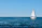 white sailboat on sea under blue sky during daytime