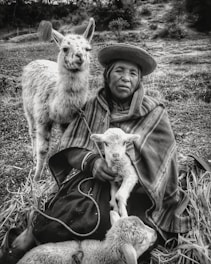 A researcher interviewing an elder in a traditional village setting.