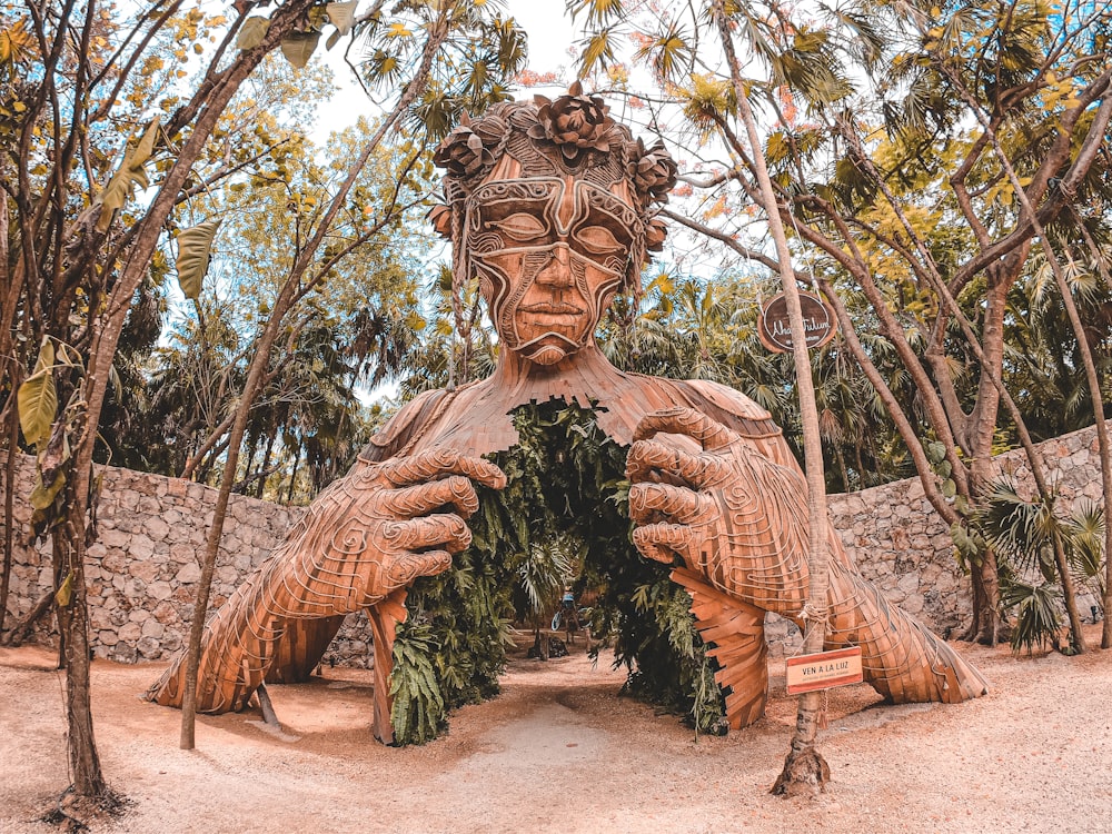 brown wooden statue on brown soil
