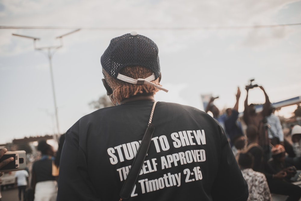 man in black and white hoodie wearing black knit cap