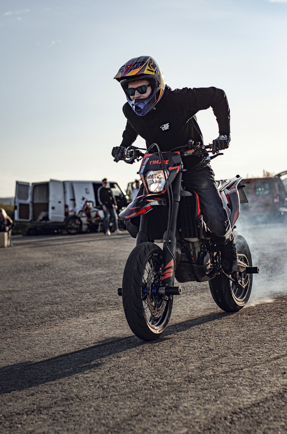 man in black and red motorcycle suit riding motorcycle