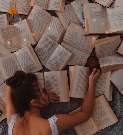 woman in white tank top reading book