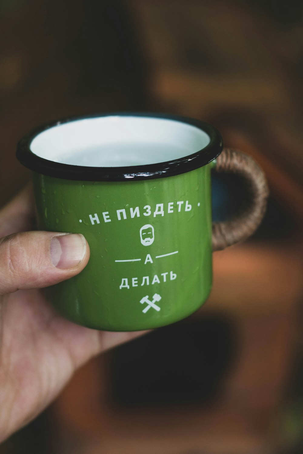 green and black ceramic mug with coffee