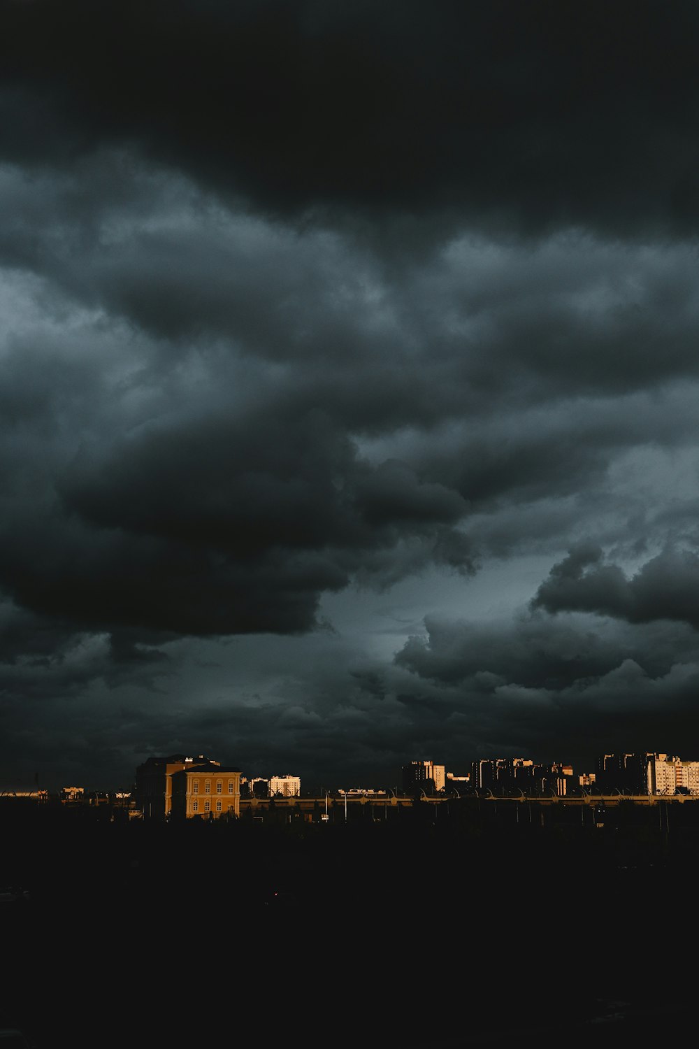 city skyline under dark clouds